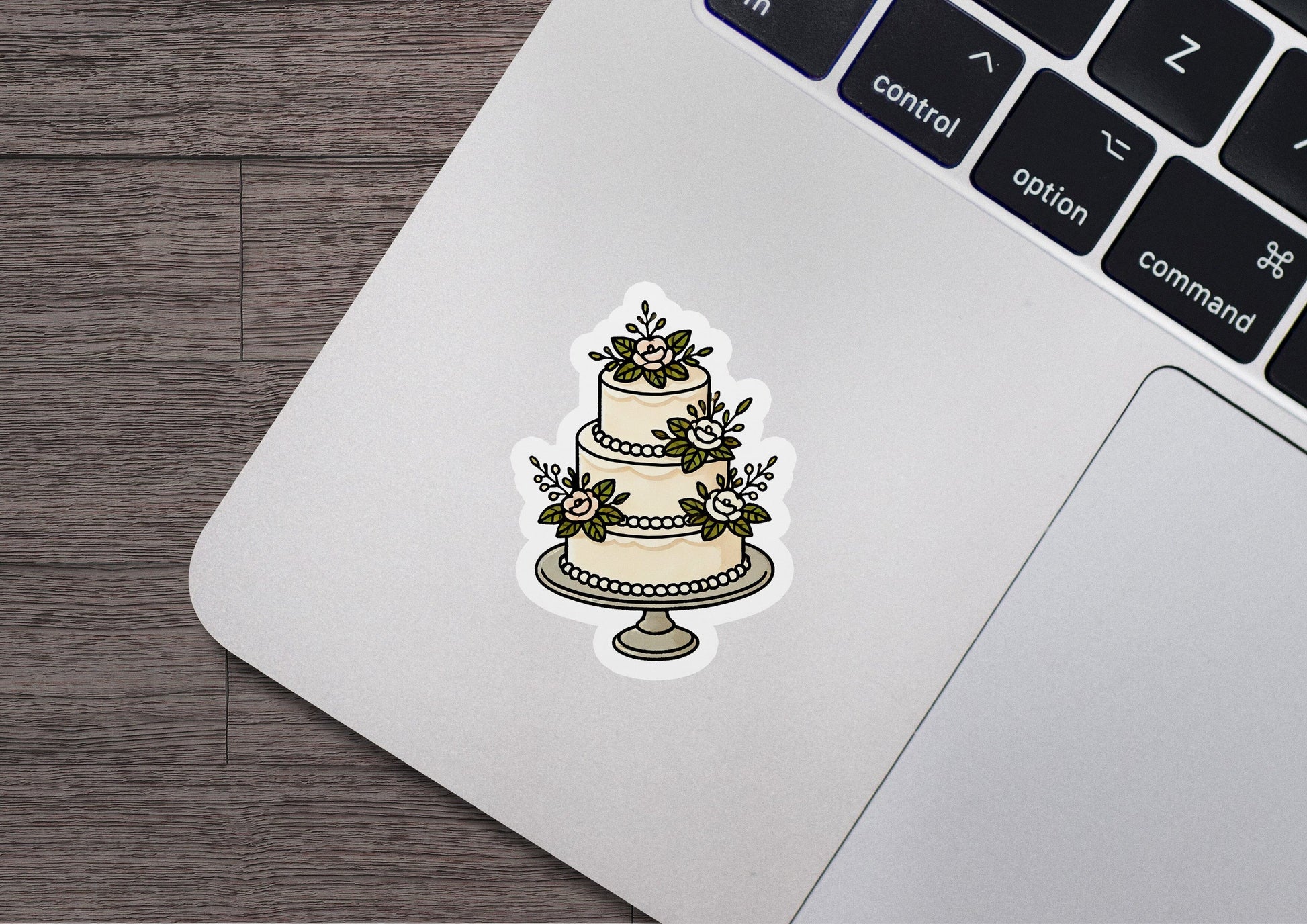 a sticker of a wedding cake on a laptop