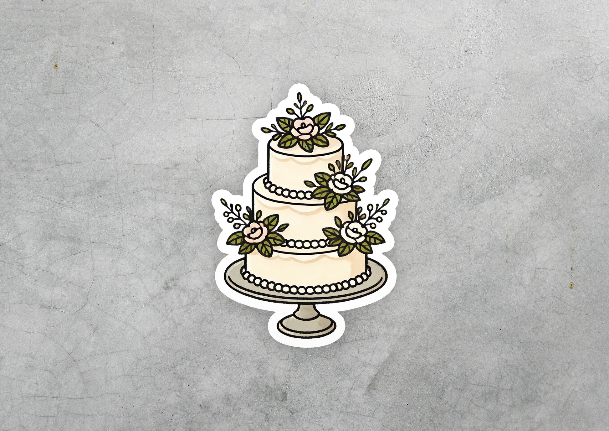 a sticker of a wedding cake with flowers on it