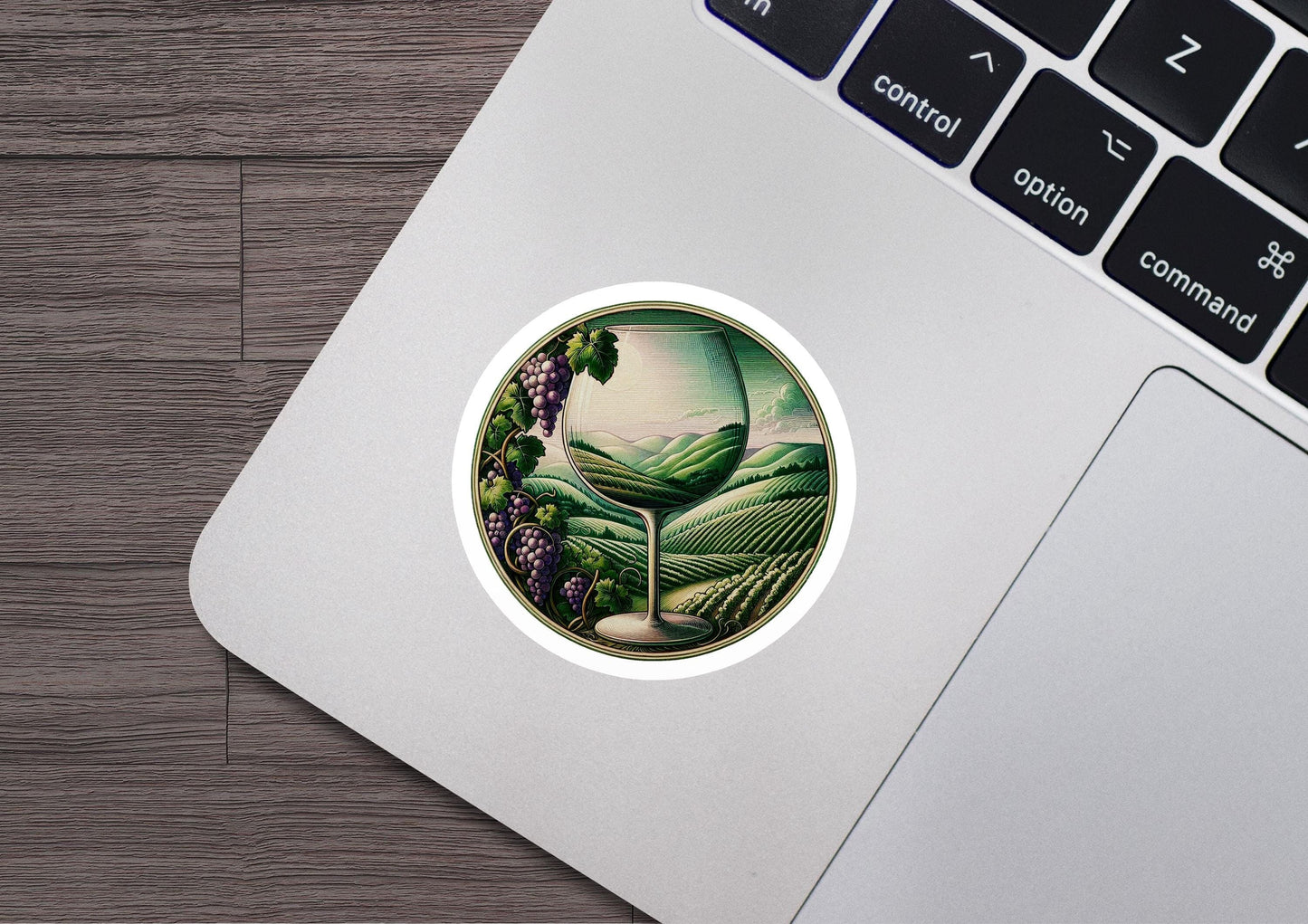 a laptop with a sticker of a vineyard