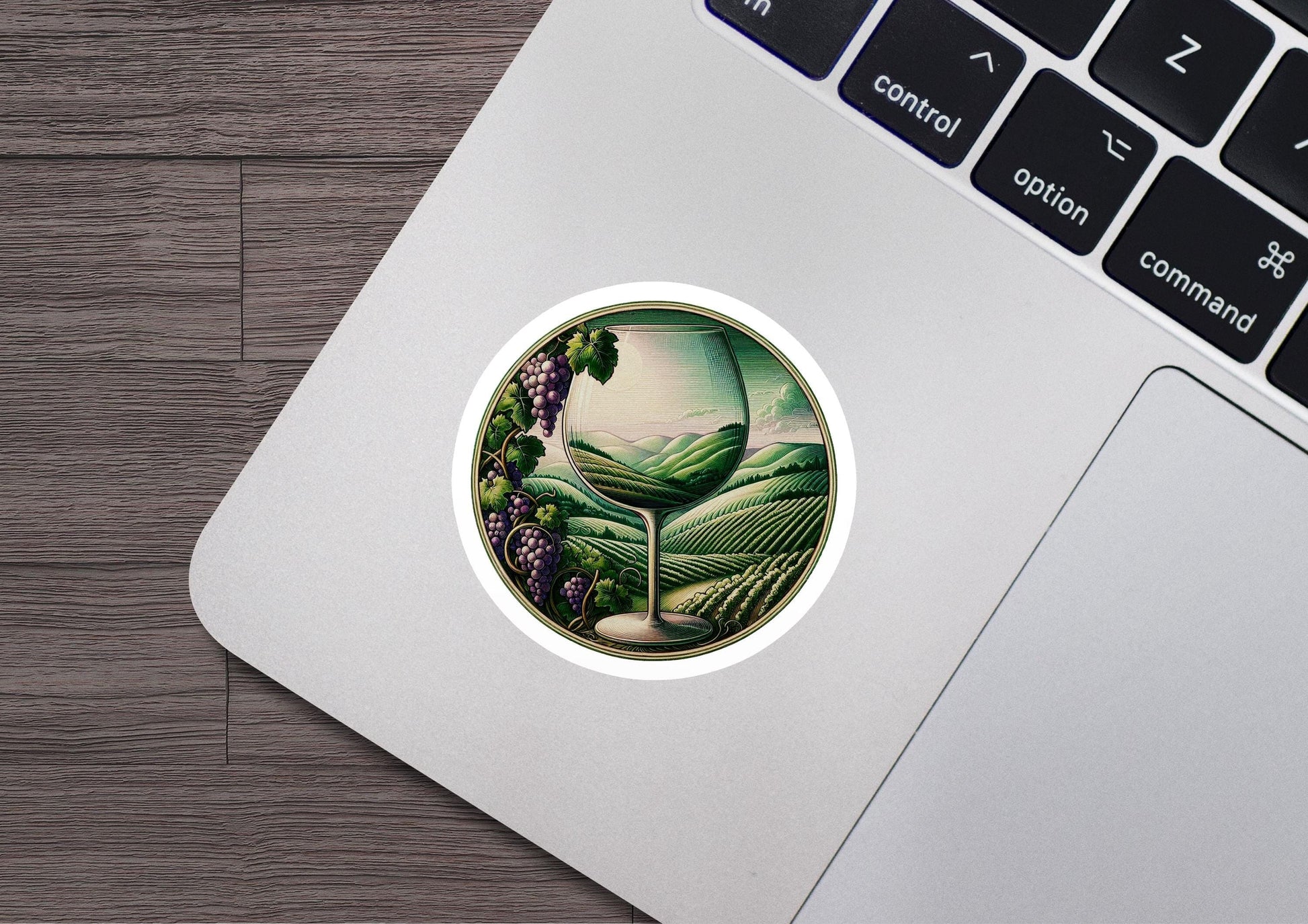 a laptop with a sticker of a vineyard