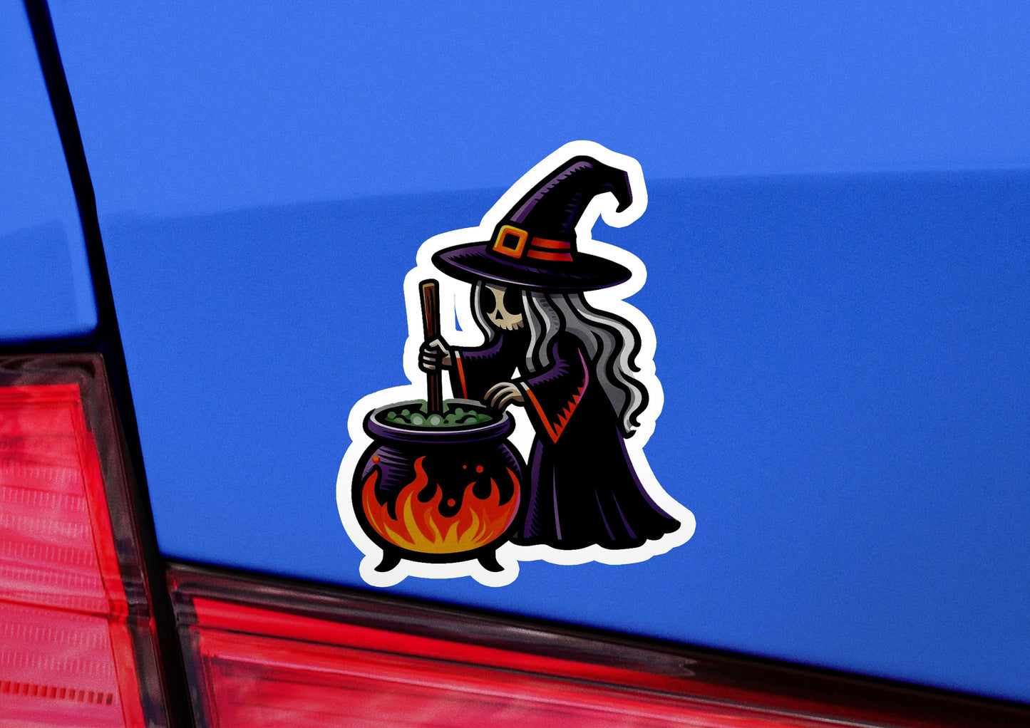 a car with a sticker of a witch holding a caulder