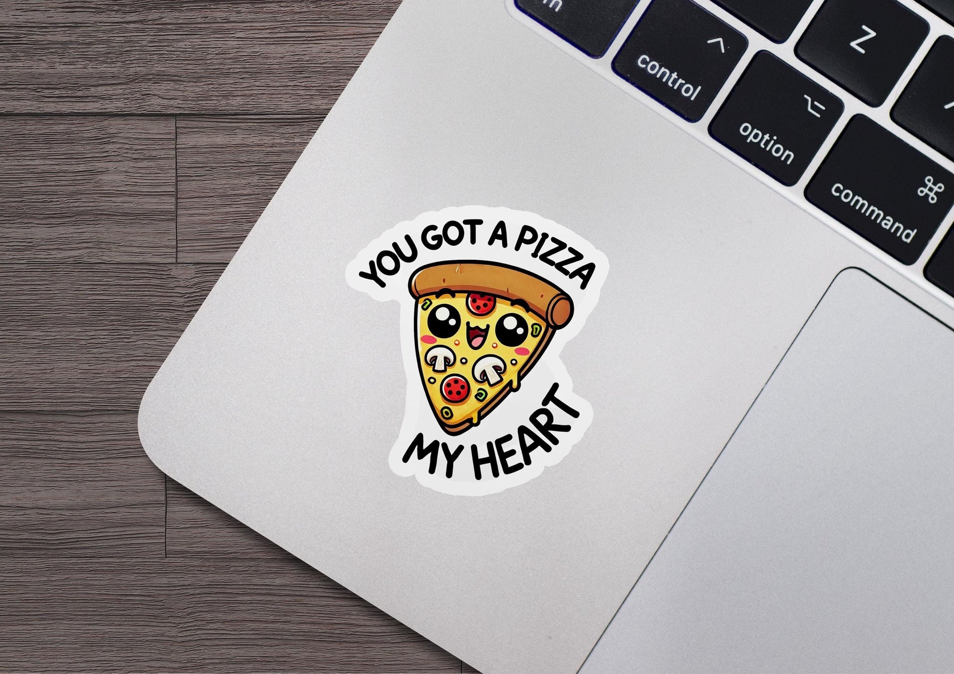 a laptop with a sticker of a slice of pizza on it