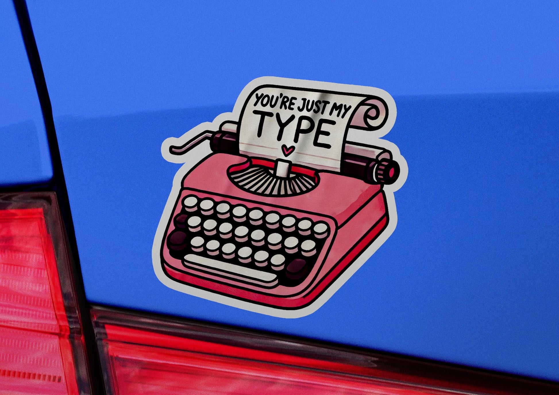 a sticker of a typewriter on the back of a car