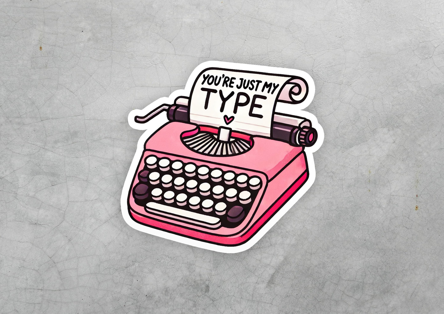 a pink sticker with a typewriter on it