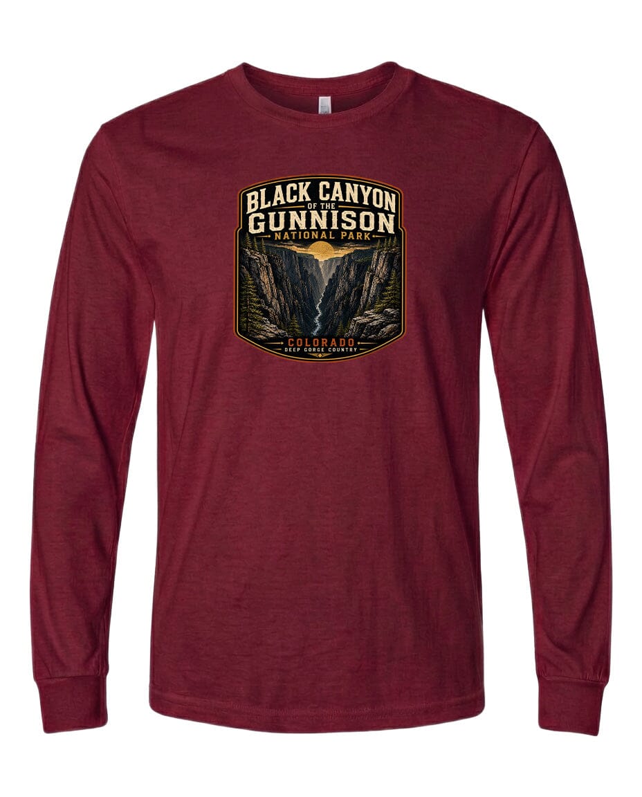 A red long-sleeved t-shirt with a graphic design depicting a mountainous landscape, specifically the Black Canyon of the Gunnison National Park.