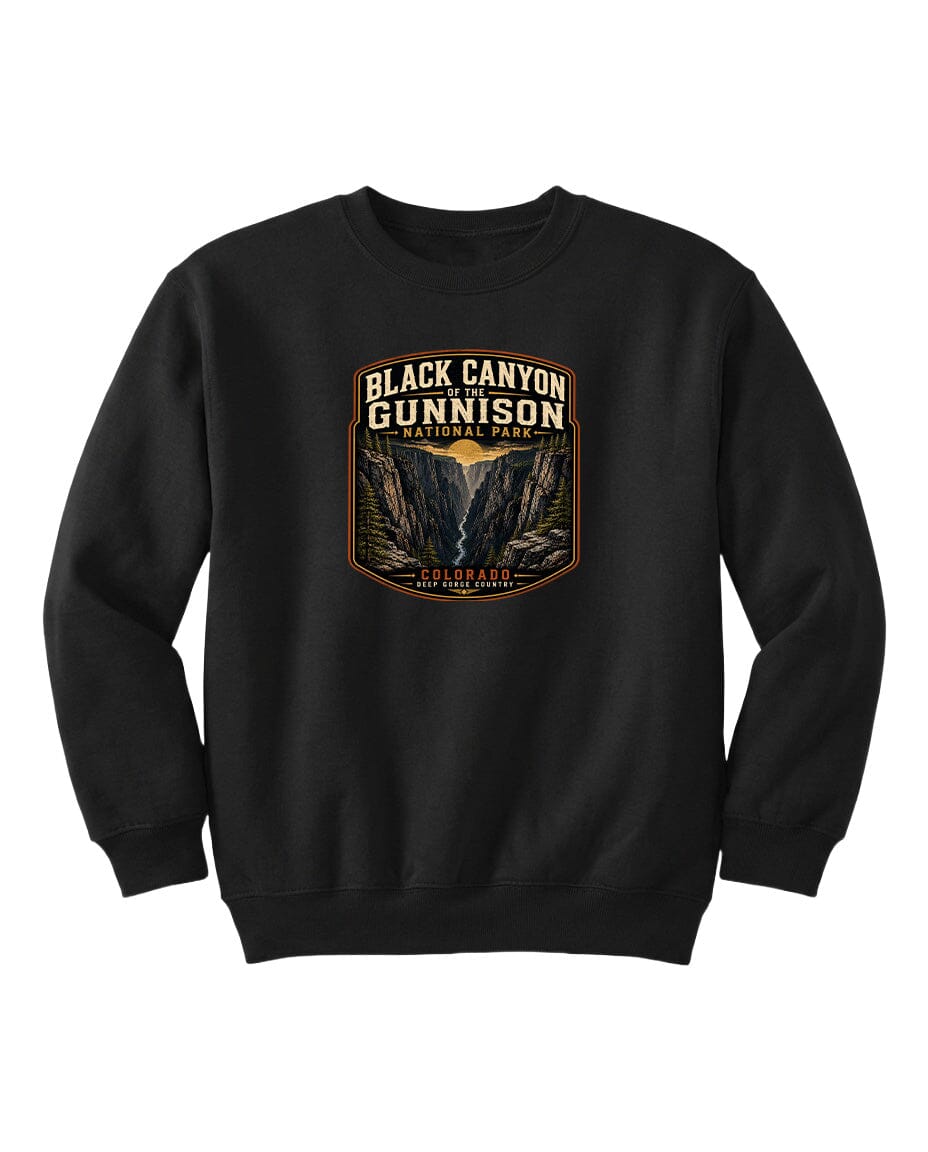 A black sweatshirt with a graphic design featuring the text "Black Canyon Gunnison National Park" and an illustration of the Black Canyon in the Colorado Plateau.