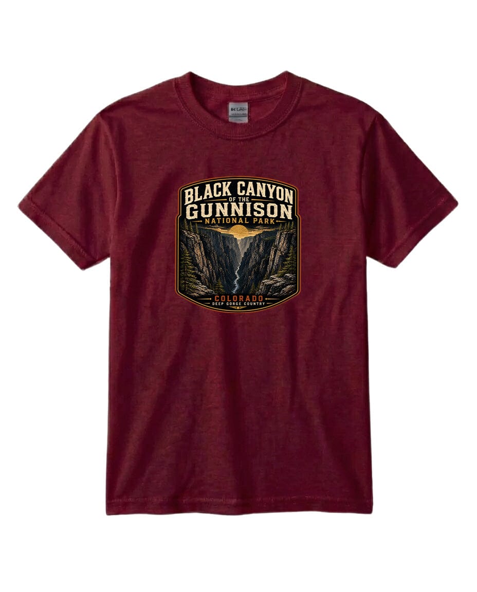 A burgundy-colored t-shirt with a graphic design depicting the Black Canyon of the Gunnison National Park.