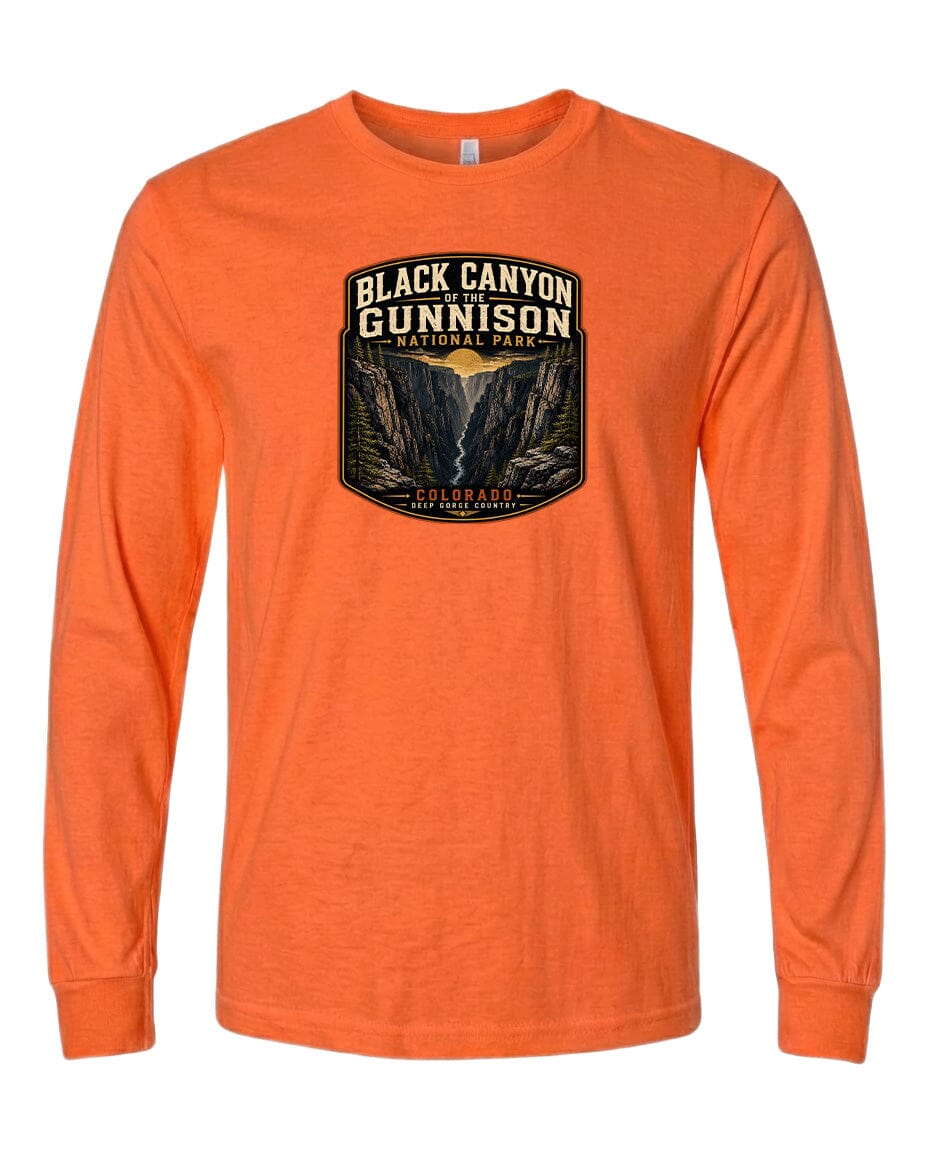An orange long-sleeved t-shirt with a graphic design depicting the Black Canyon of the Gunnison National Park.