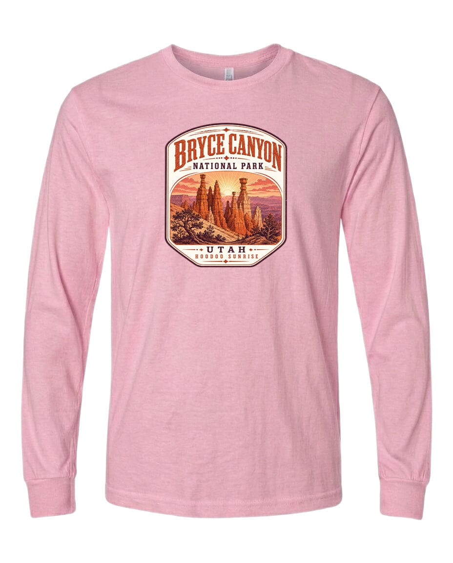 A pink long-sleeved t-shirt with a graphic design depicting Bryce Canyon National Park and Utah.