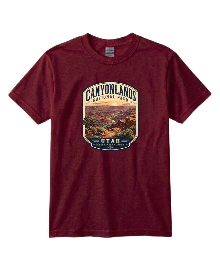 A burgundy-colored t-shirt with a graphic design depicting a scenic landscape, including a canyon and a river, with the text "CANYONLANDS NATIONAL PARK UTAH DESERT MOUNTAIN COUNTRY" printed on it.
