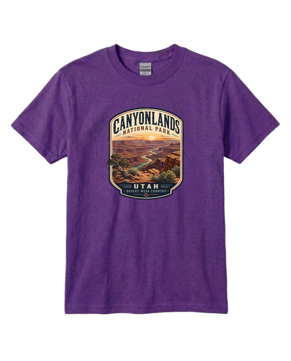 A purple t-shirt with a graphic design depicting a scenic landscape, including a canyon and a river, with the text "CANYONLANDS NATIONAL PARK UTAH DESERT MESERICA" printed on it.