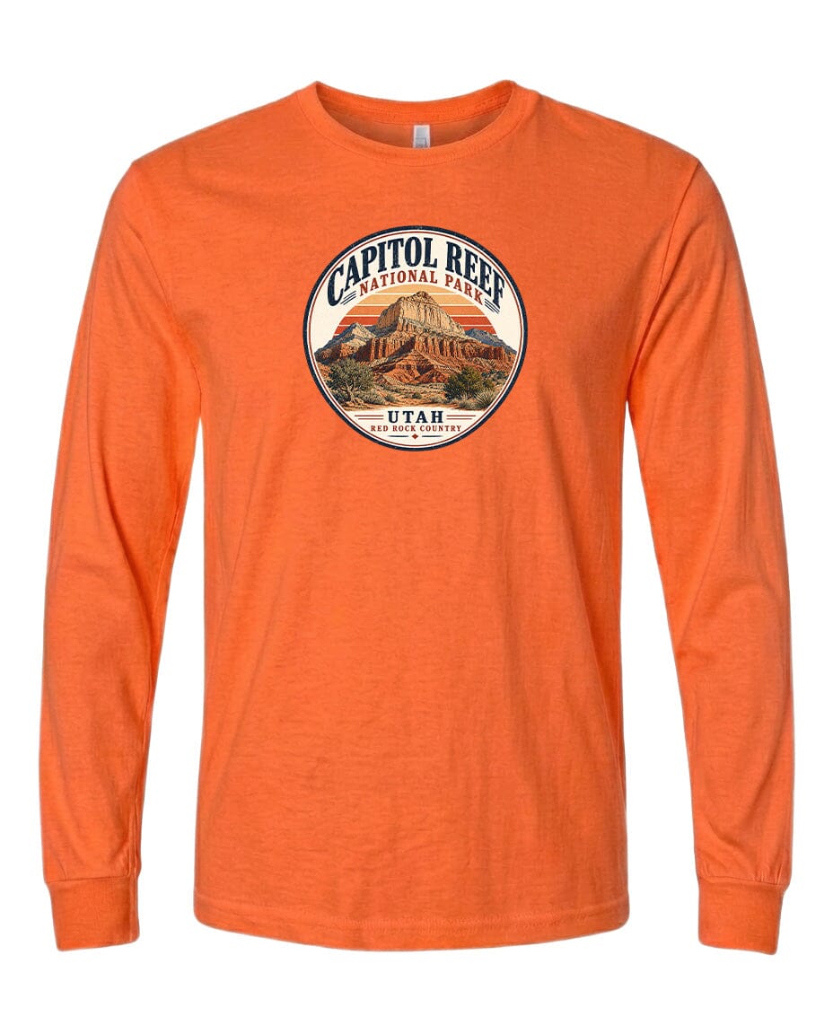 An orange long-sleeved t-shirt with a circular design featuring the Capitol Reef National Park logo and a mountain landscape.
