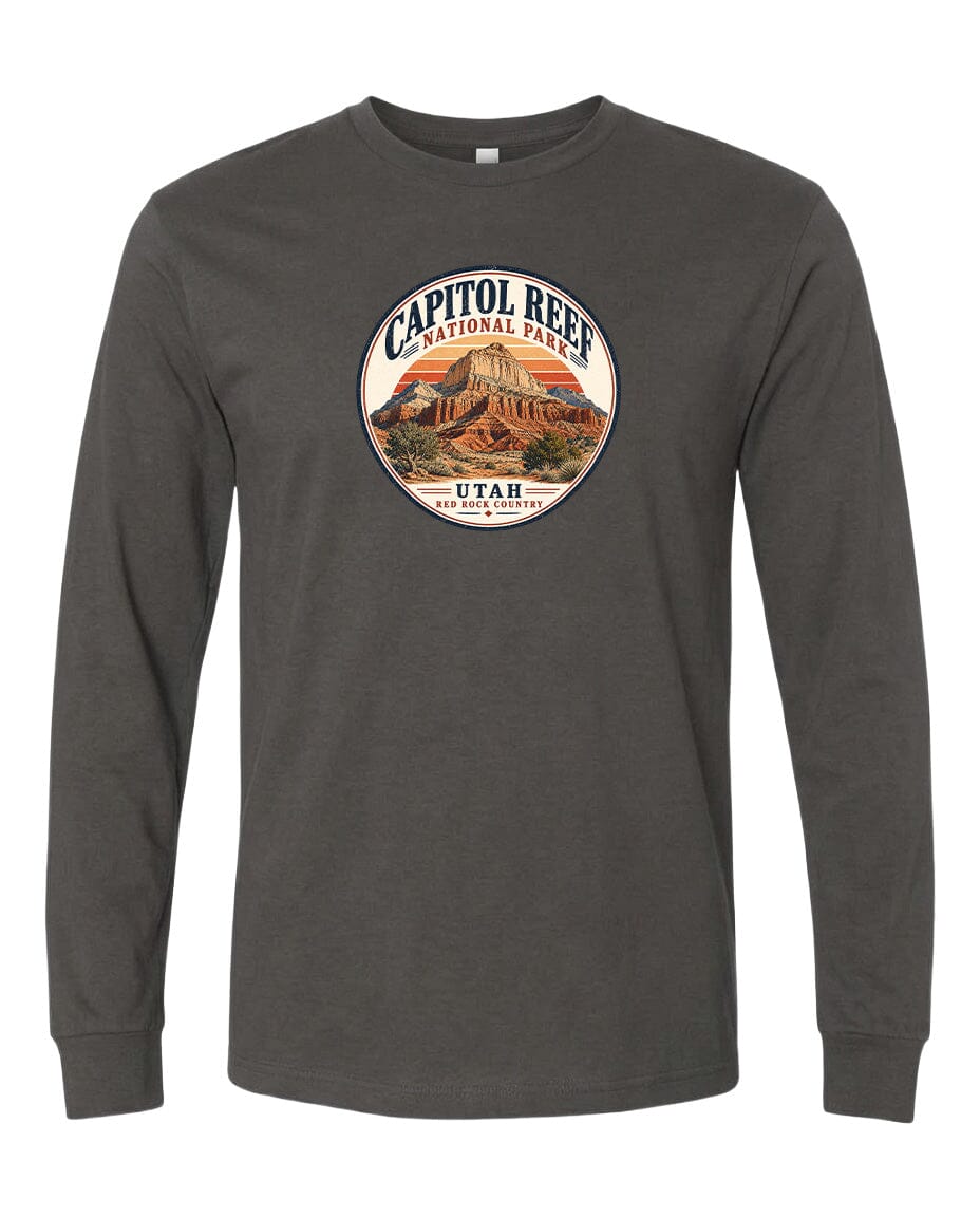 A gray long-sleeved t-shirt with a circular design featuring the Capitol Reef National Park logo and a mountain landscape.