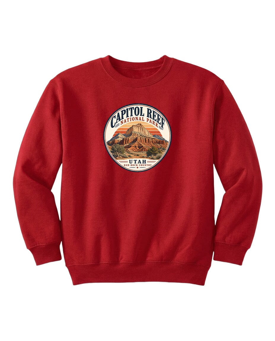 A red sweatshirt with a circular design featuring the Capitol Reef National Park logo and the text "UTAH" printed on it.