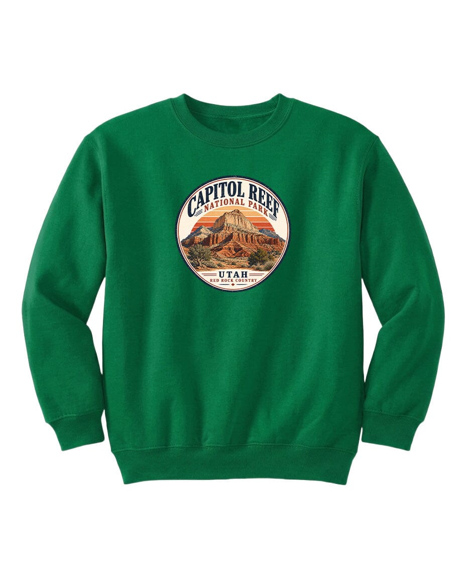 A green sweatshirt with a circular logo that says "CAPITOL REEF NATIONAL PARK UTAH" and features an illustration of a mountain range.