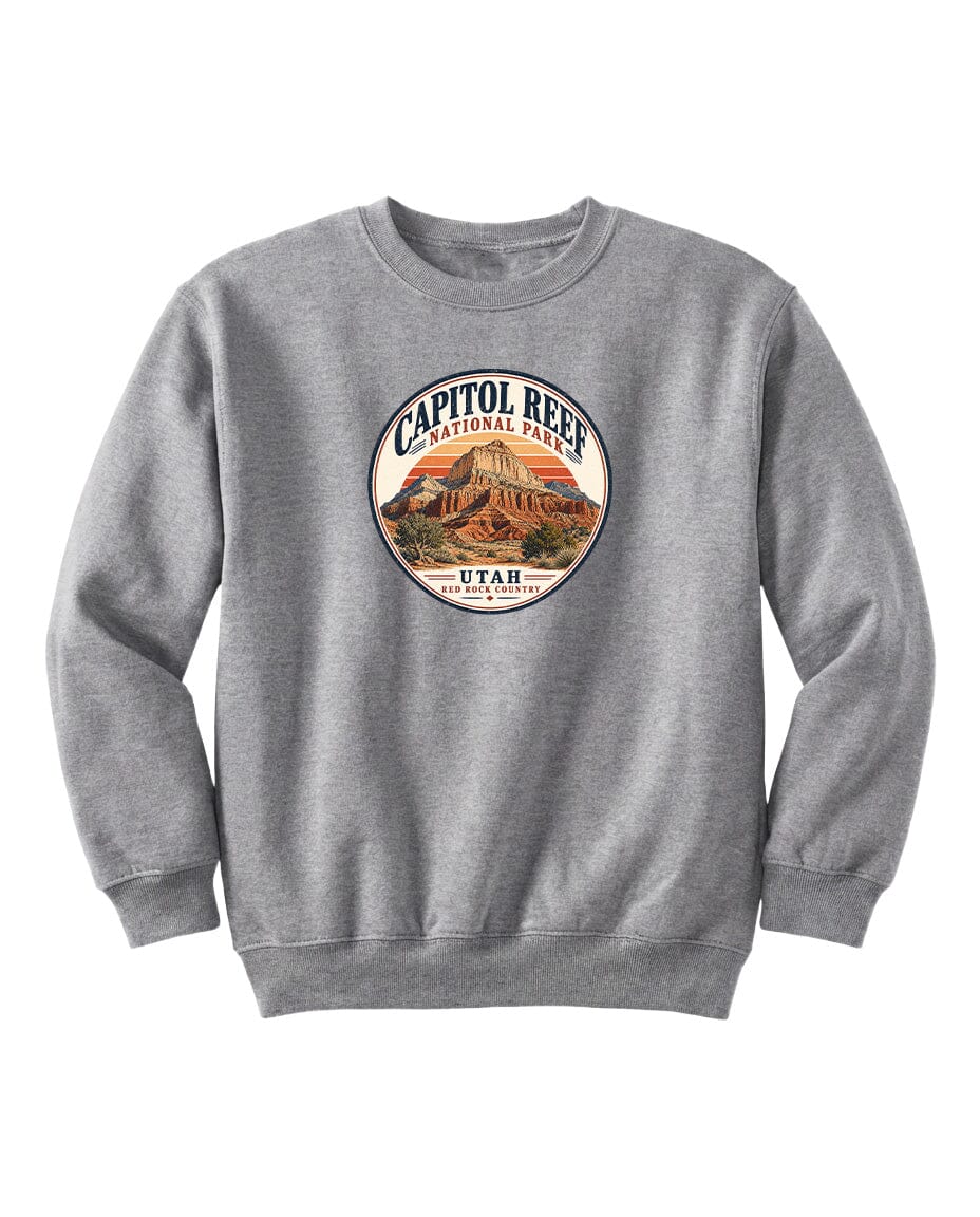 A gray sweatshirt with a circular logo featuring an image of a mountain and the text "CAPITOL REEF NATIONAL PARK UTAH" printed on it.