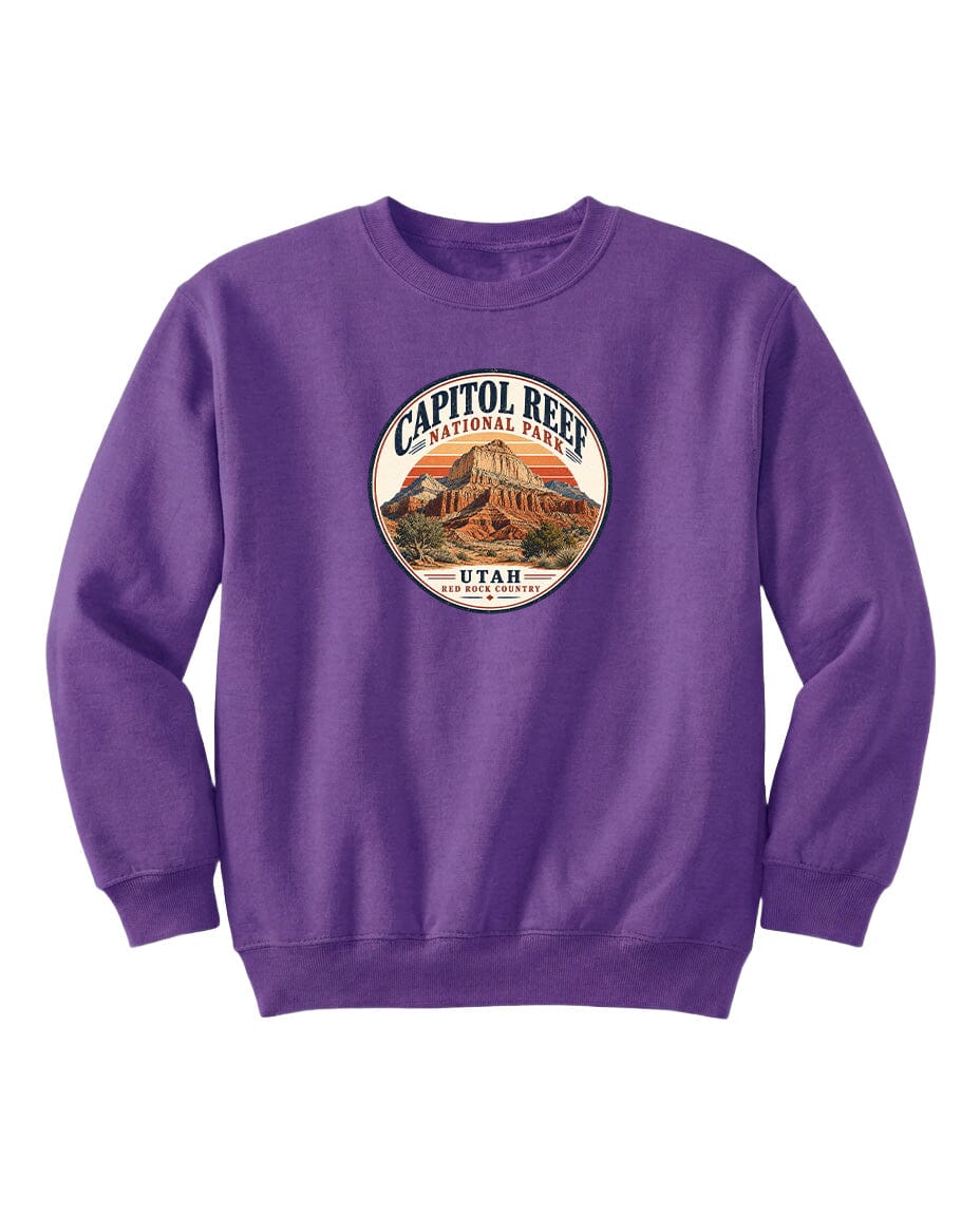 A purple sweatshirt with a circular design featuring the Capitol Reef National Park logo and the text "UTAH" printed on it.