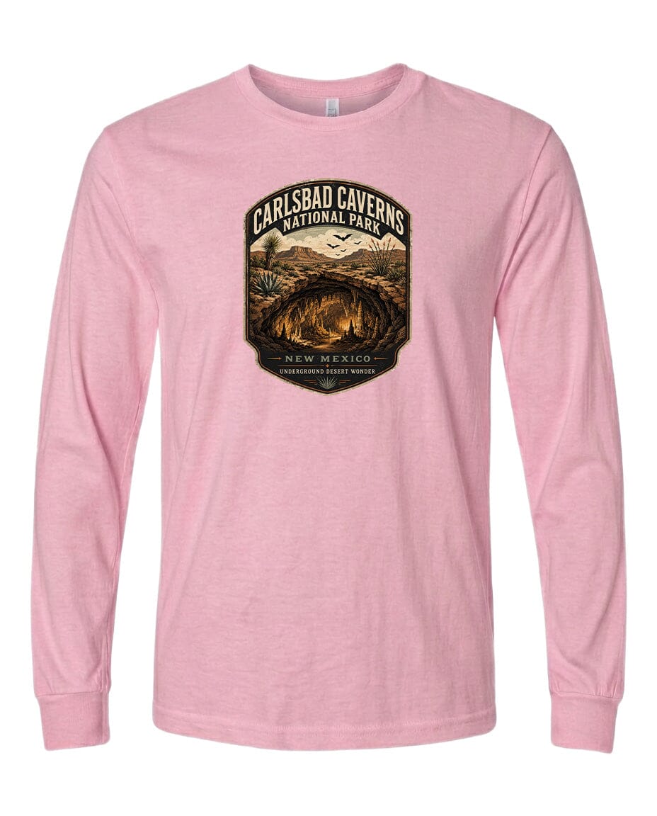 A pink long-sleeved t-shirt with a graphic design depicting the Carlsbad Caves National Park in New Mexico.