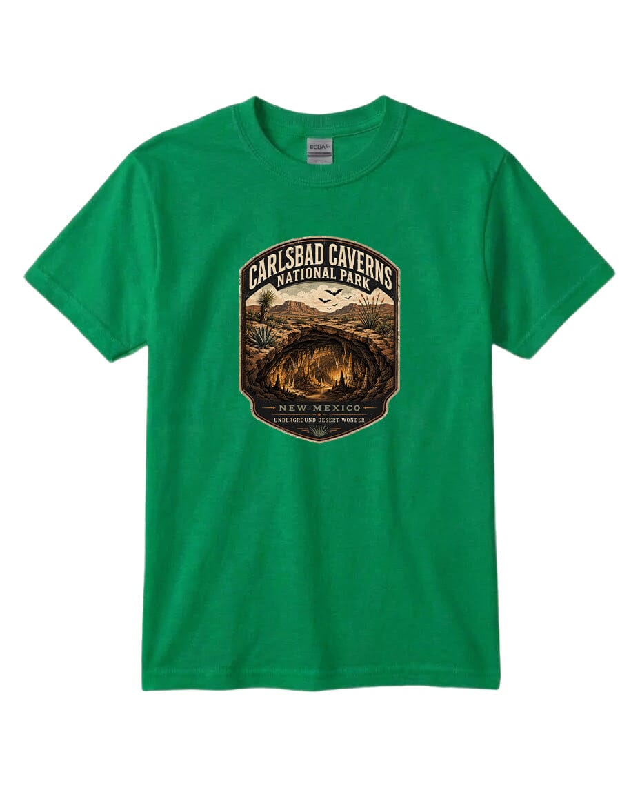 A green t-shirt with a graphic design featuring a cave and mountains, along with the text "CARLSBAD CAVENS NATIONAL PARK NEW MEXICO UNDERGROUND WONDERS".