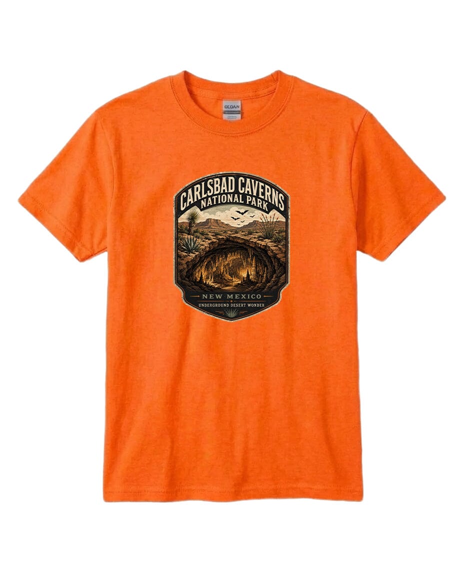An orange t-shirt with a graphic design depicting the entrance to Carlsbad Caverns National Park in New Mexico.