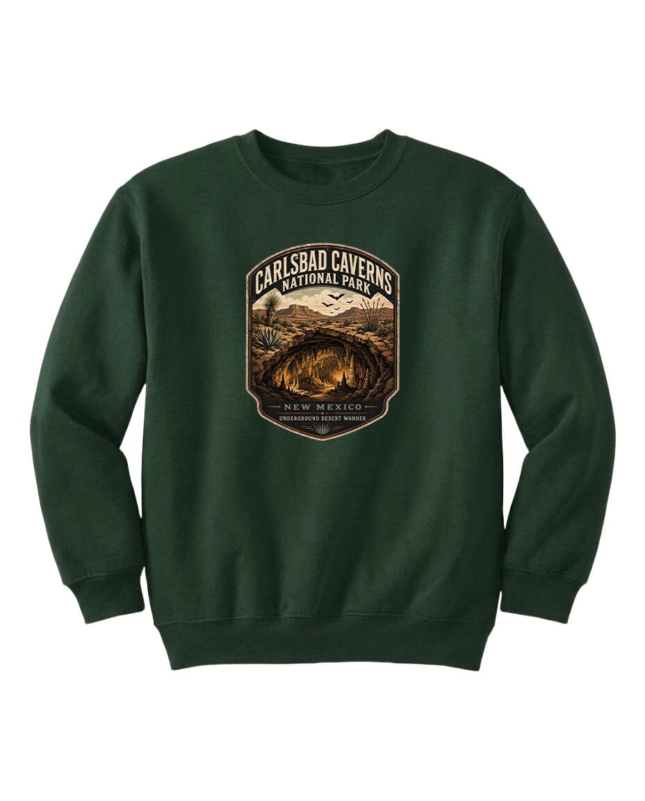 A green sweatshirt with a graphic design featuring a desert landscape and the text "CARLSBAD CAVERSNATIONAL PARK NEW MEXICO UNDERGROUND WONDER".
