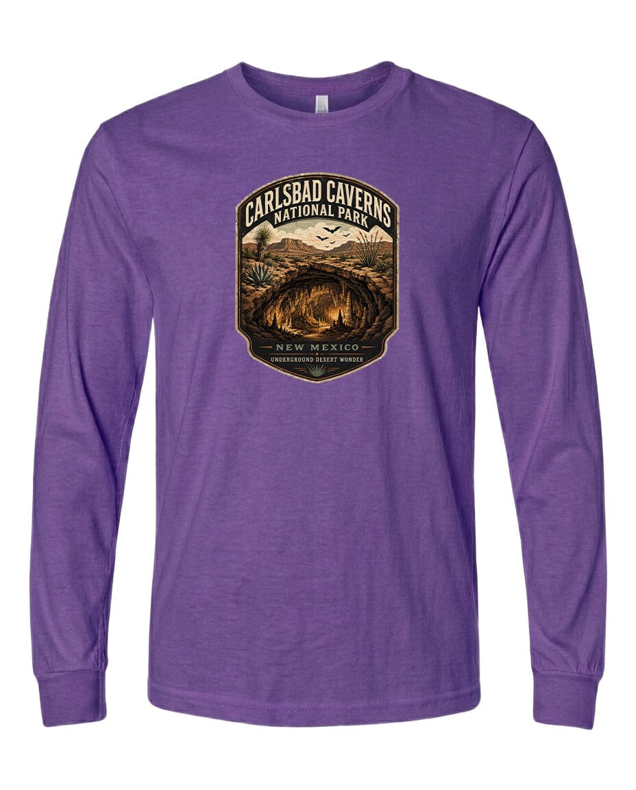 A purple long-sleeved t-shirt with a graphic design featuring the Carlsbad Caves National Park in New Mexico.