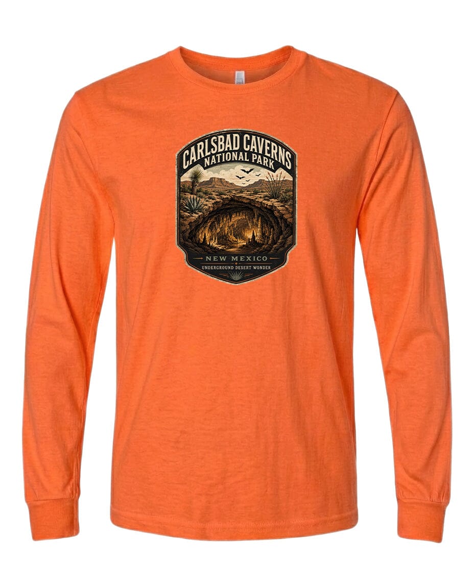 An orange long-sleeved t-shirt with a graphic design featuring the Carlsbad Caves National Park logo.