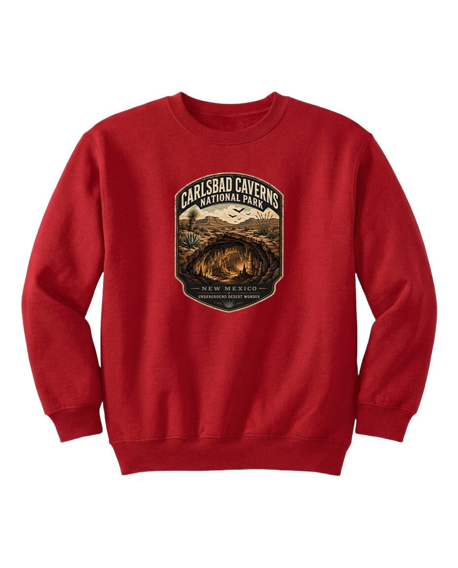 A red sweatshirt with a graphic design featuring a desert landscape and the text "CARLSBAD CAVERSNATIONAL PARK NEW MEXICO UNDERGROUND WONDER".