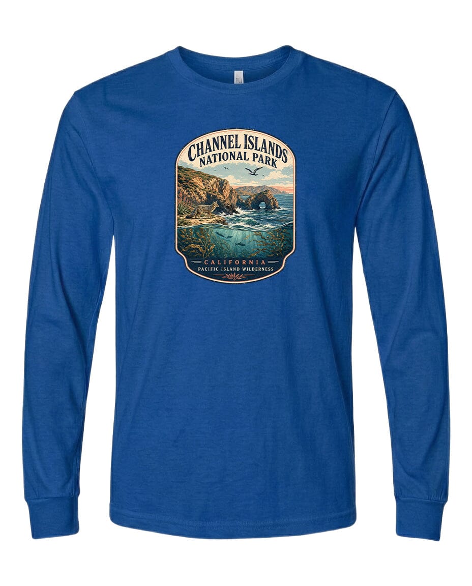 A blue long-sleeved t-shirt with a graphic design depicting a scenic coastal landscape, including cliffs, water, and a sunset.
