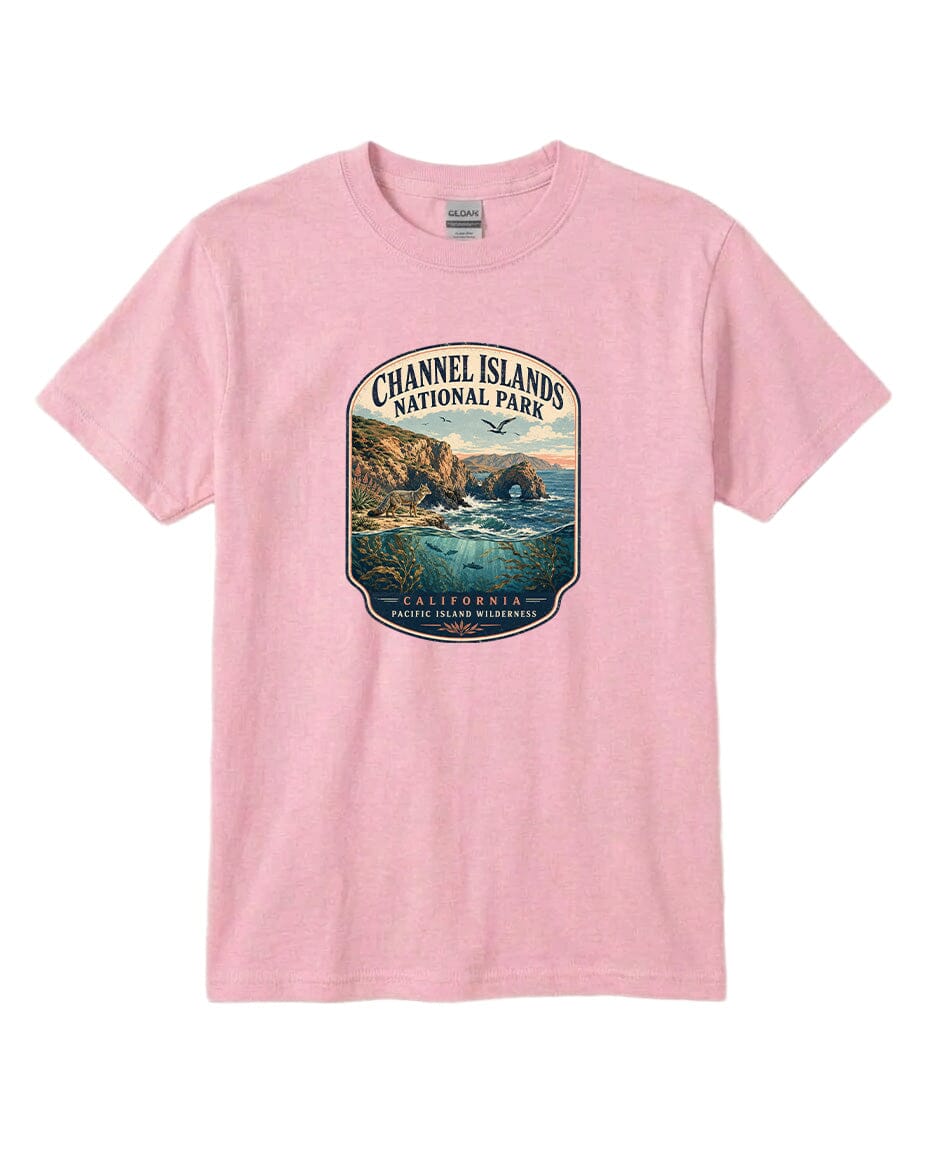 A pink t-shirt with a graphic design depicting a scenic coastal landscape, including cliffs, water, and a bird in flight.