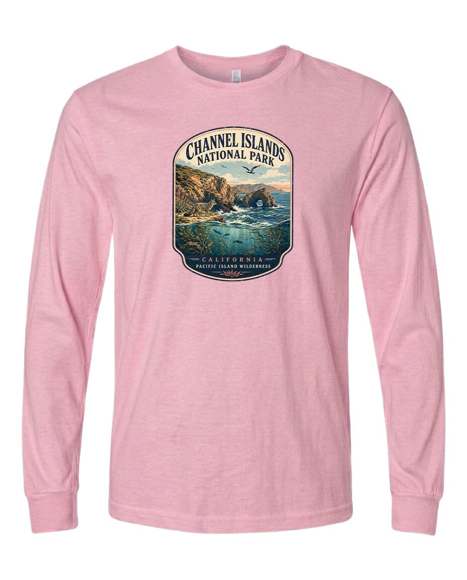 A pink long-sleeved t-shirt with a graphic design depicting a scenic coastal landscape, including cliffs, water, and a sunset.