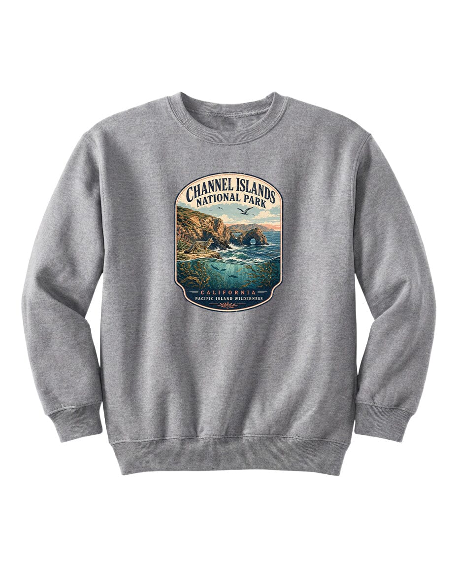 A gray sweatshirt with a graphic design depicting a scenic coastal landscape with cliffs, water, and a sunset sky.