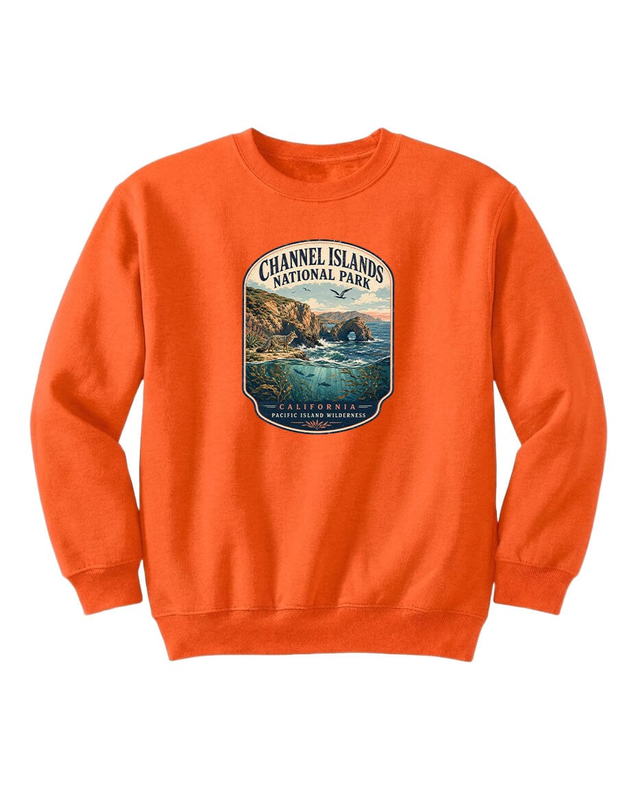An orange sweatshirt with a graphic design depicting a scenic coastal landscape, including cliffs, water, and a bird in flight.