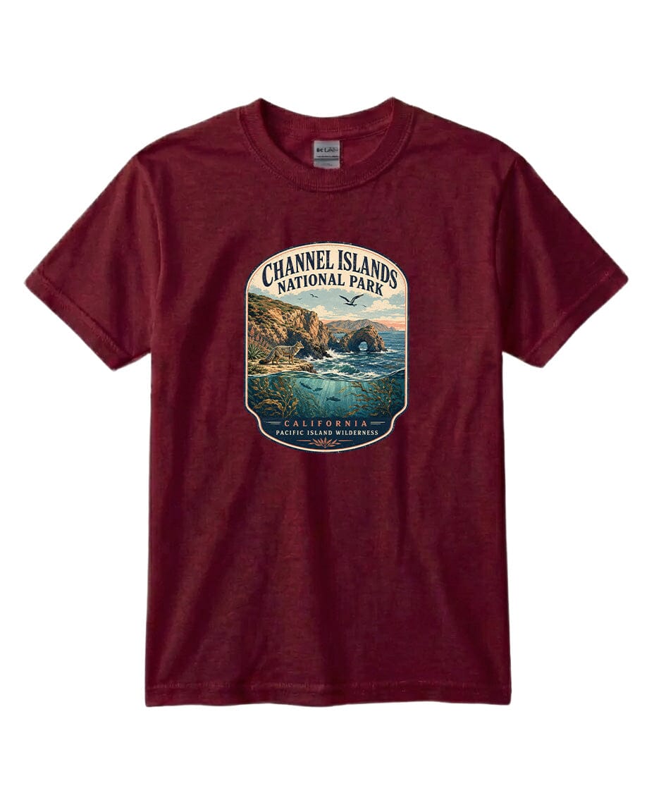 A maroon t-shirt with a graphic design depicting a scenic coastal landscape, including cliffs, water, and a bird in flight.