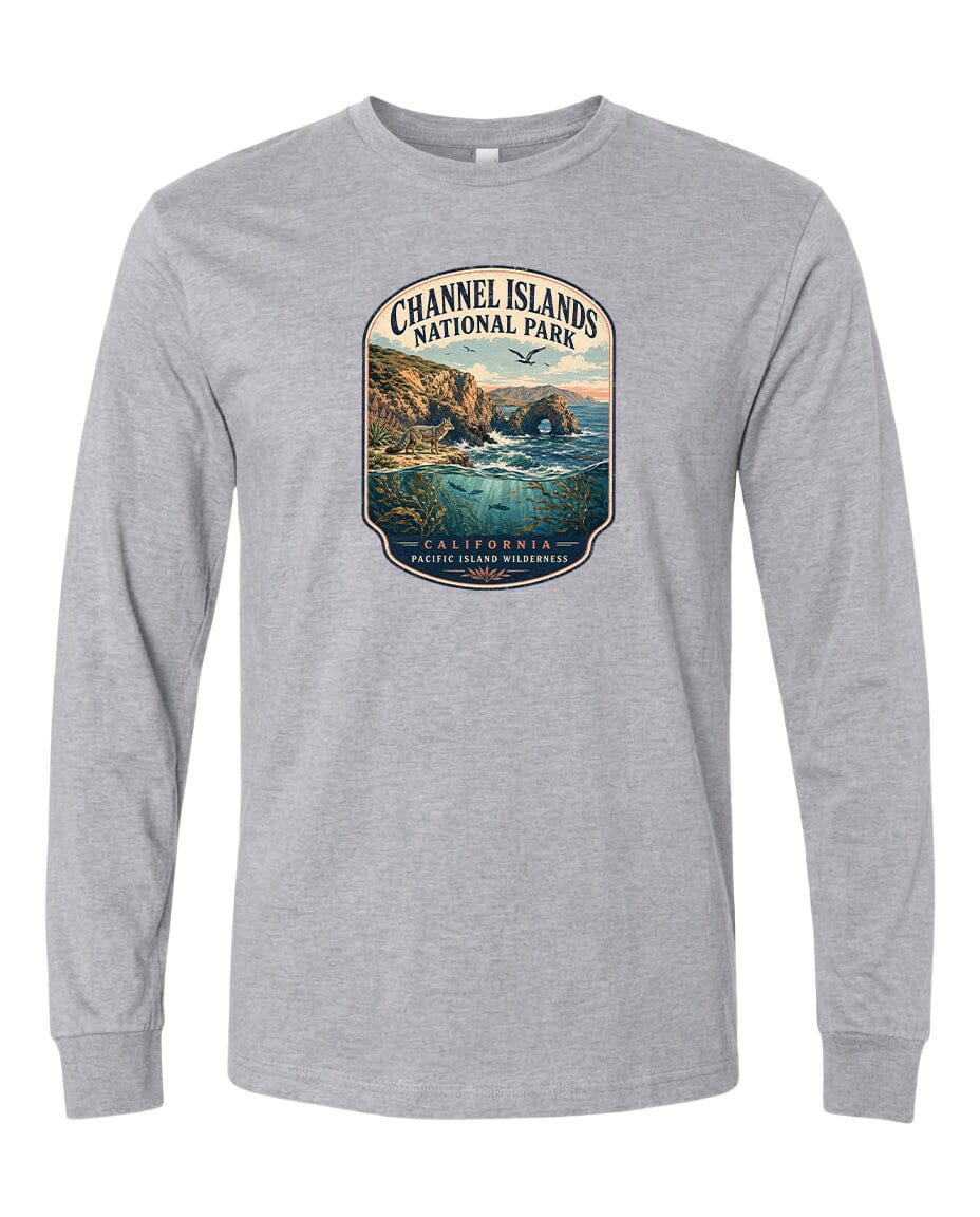 A gray long-sleeved t-shirt with a graphic design depicting a scenic coastal landscape, including cliffs, water, and a sunset.