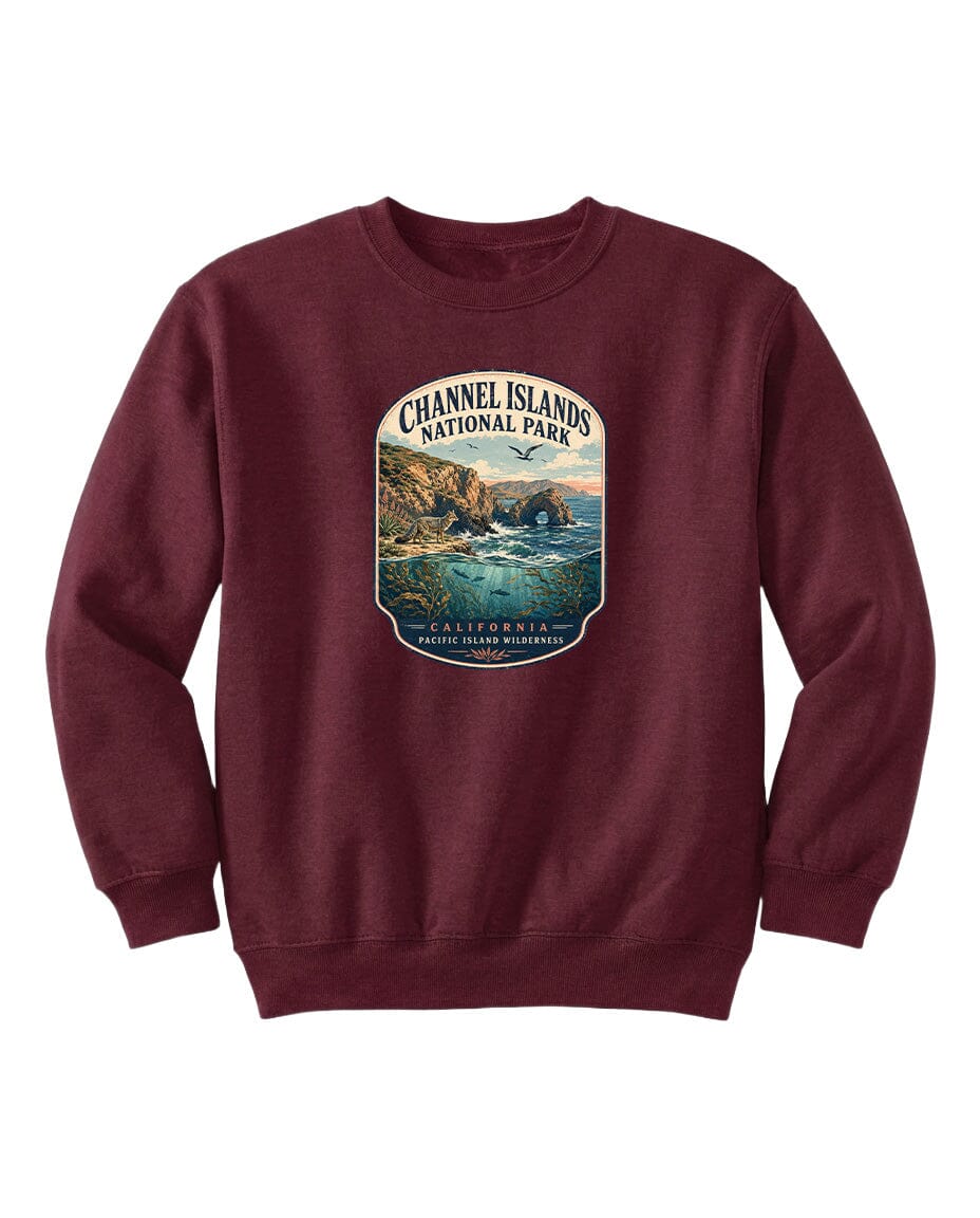 A burgundy sweatshirt with a graphic design depicting a scenic coastal landscape, including cliffs, water, and a sunset.