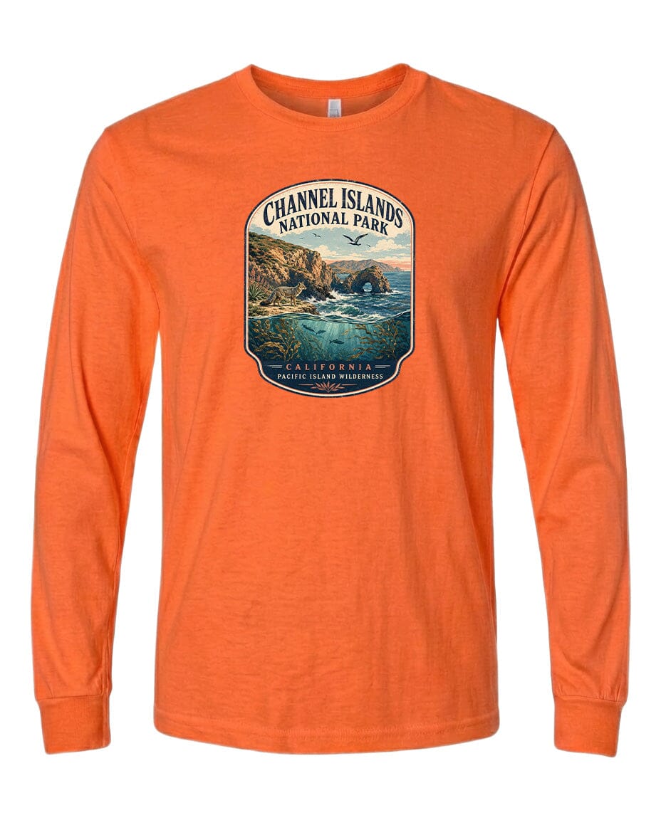 An orange long-sleeved t-shirt with a graphic design depicting a scenic coastal landscape, including cliffs, water, and a beach.
