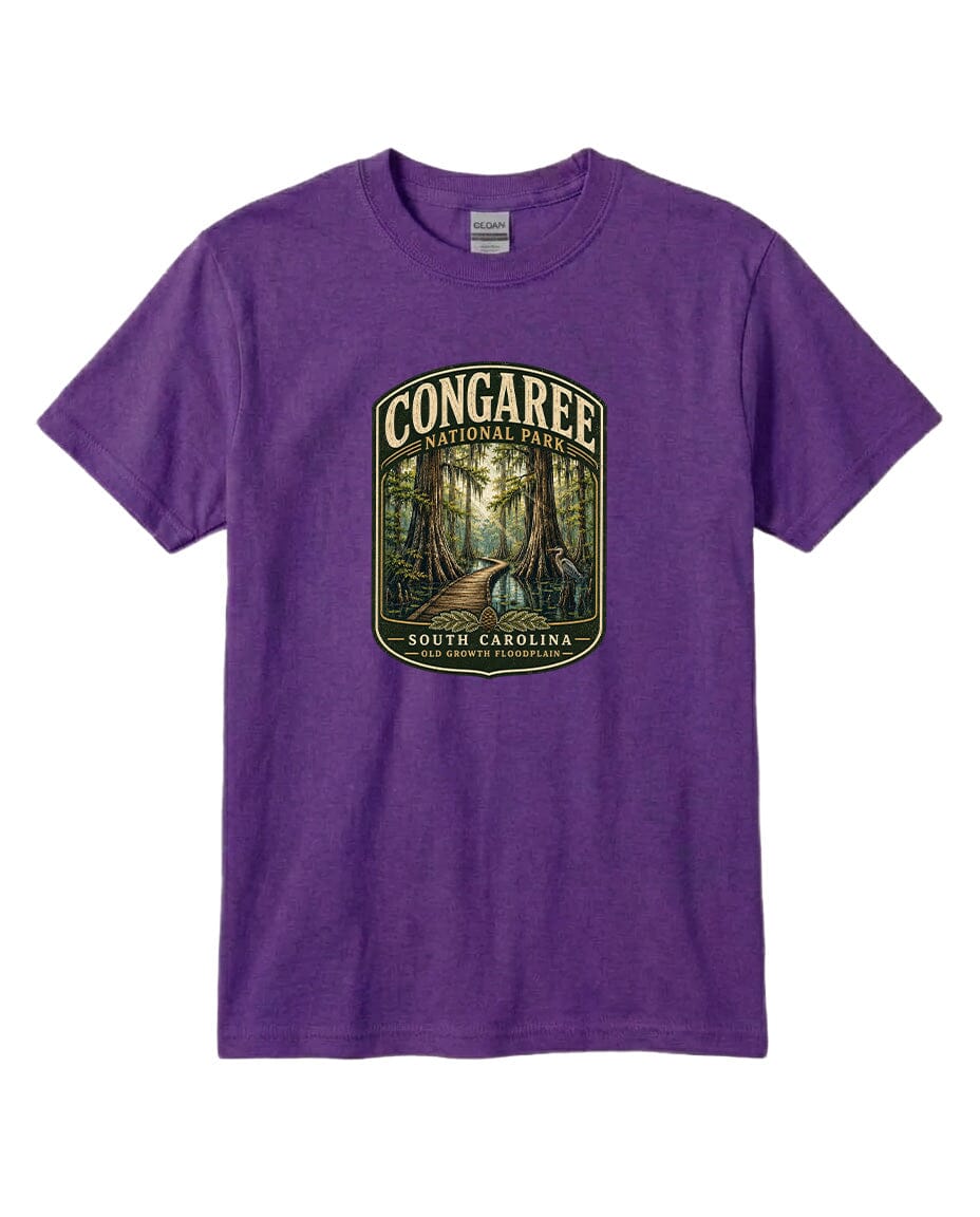 A purple t-shirt with a graphic design depicting a forest scene, featuring a path leading through the trees.