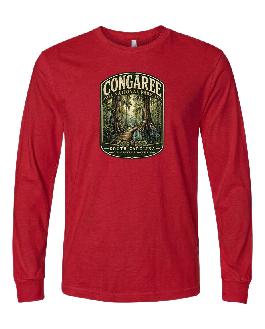 A red long-sleeved t-shirt with a graphic design depicting a forest scene, featuring a path leading through the trees.