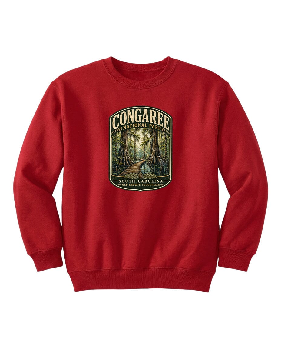 A red sweatshirt with a graphic design depicting a forest scene, featuring the text "CONGAREE NATIONAL PARK SOUTH CAROLINA" prominently displayed.
