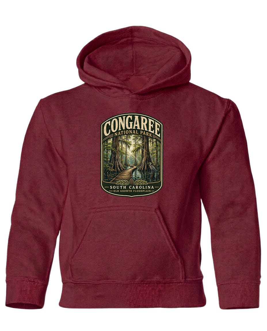 A red hooded sweatshirt with a graphic design depicting a forest scene and the text "CONGAREE NATIONAL PARK SOUTH CAROLINA" printed on it.