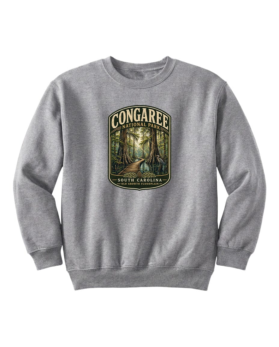 A gray sweatshirt with a graphic design depicting a forest scene and the text "CONGAREE NATIONAL PARK SOUTH CAROLINA" printed on it.
