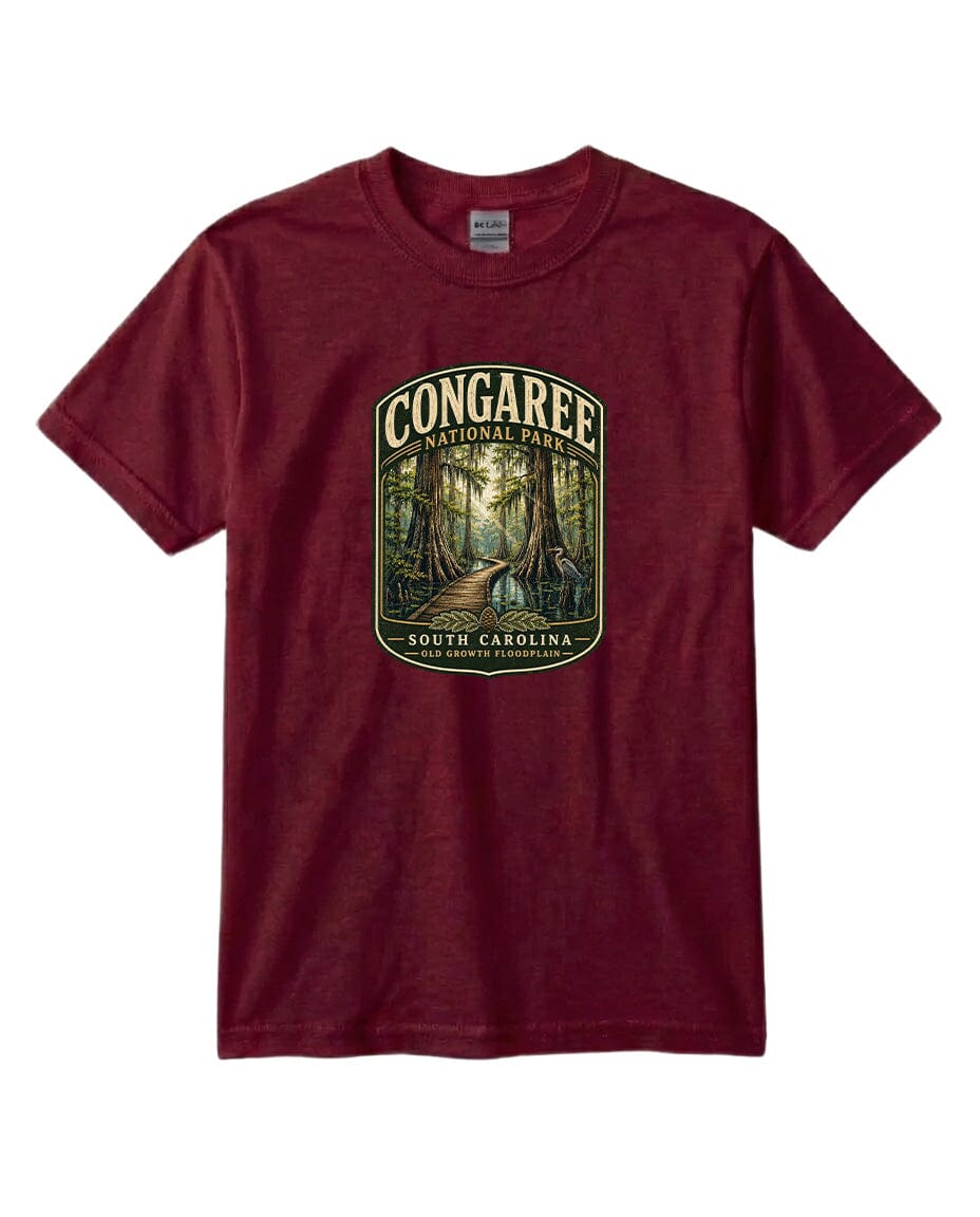 A maroon t-shirt with a graphic design depicting a forest scene, featuring a path leading through the trees.