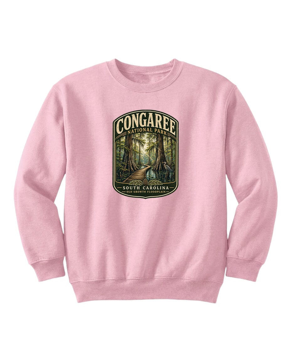A pink sweatshirt with a graphic design depicting a forest path leading through Congaree National Park in South Carolina.