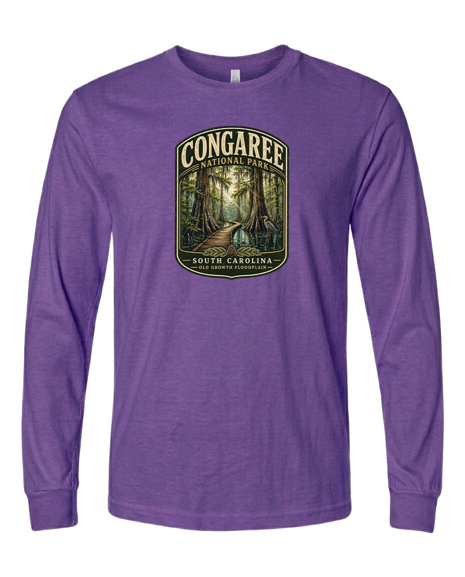 A purple long-sleeved t-shirt with a graphic design depicting a forest scene, featuring a path leading through the trees.