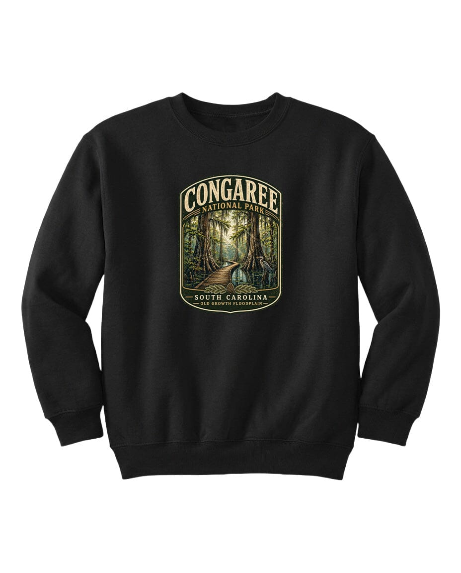 A black sweatshirt with a graphic design depicting a forest scene, featuring the text "CONGAREE NATIONAL PARK SOUTH CAROLINA" prominently displayed.