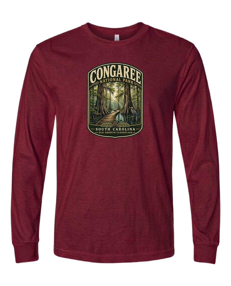 A red long-sleeved t-shirt with a graphic design depicting a forest scene, featuring a path leading through the trees.