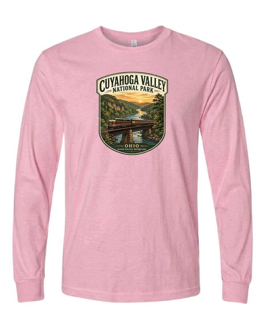 A pink long-sleeved t-shirt with a graphic design depicting a scenic view of the Cuyahoga Valley National Park, featuring a bridge, trees, and a sunset.