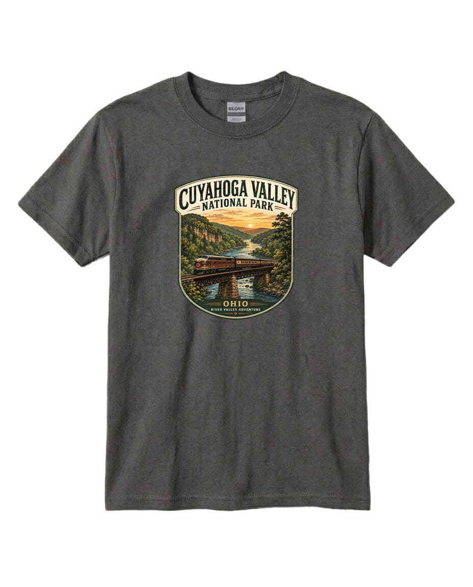 A gray t-shirt with a graphic design depicting a scenic view of the CuyaHOGA VALLEY National Park, featuring a bridge, river, and sunset.