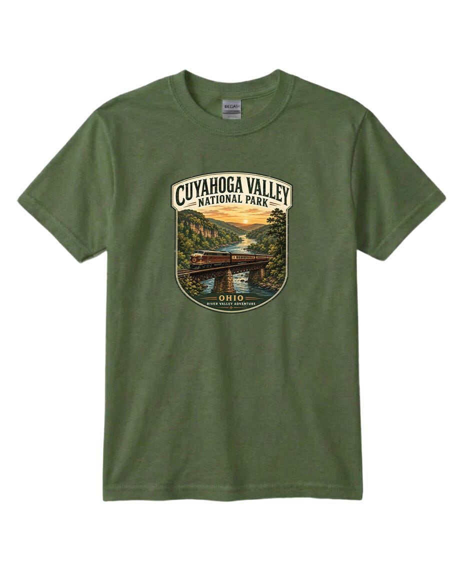 A green t-shirt with a graphic design depicting a scenic view of the Cuyaohoga Valley National Park, featuring a bridge, river, and sunset.